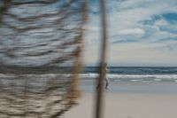 a blurry photo of a person walking on the beach