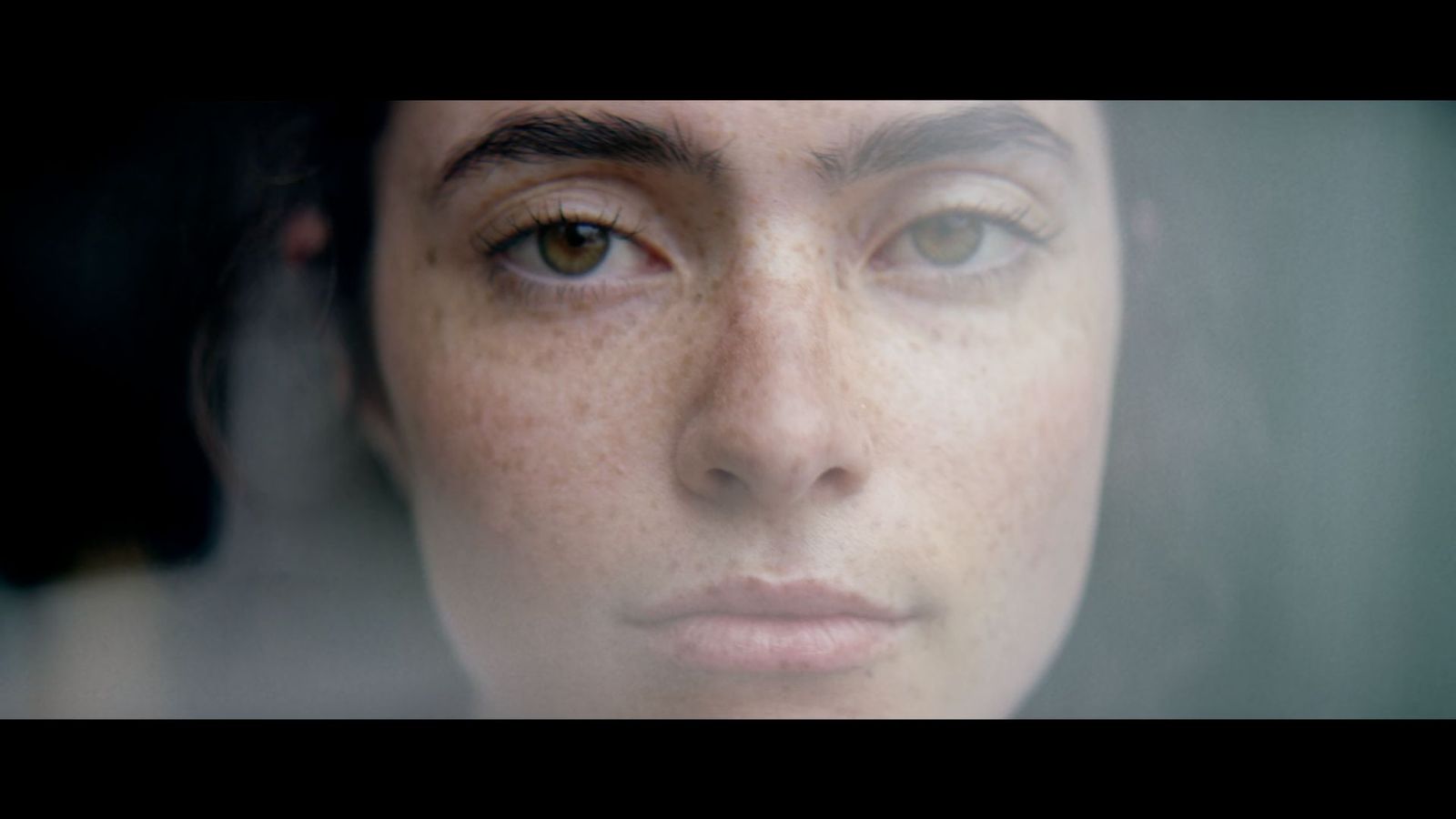 a close up of a woman with freckles on her face