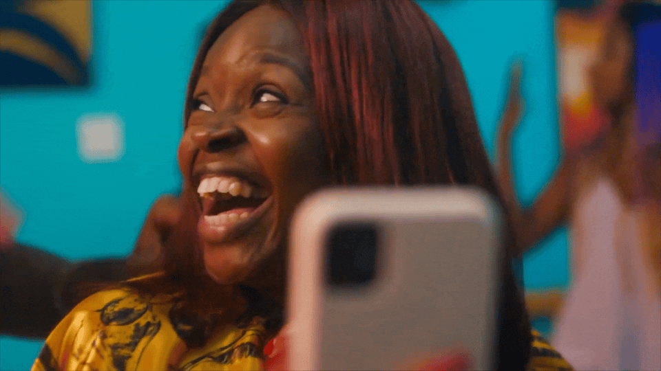 a woman taking a picture of herself with a cell phone