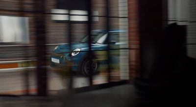 a blue car is seen through a window