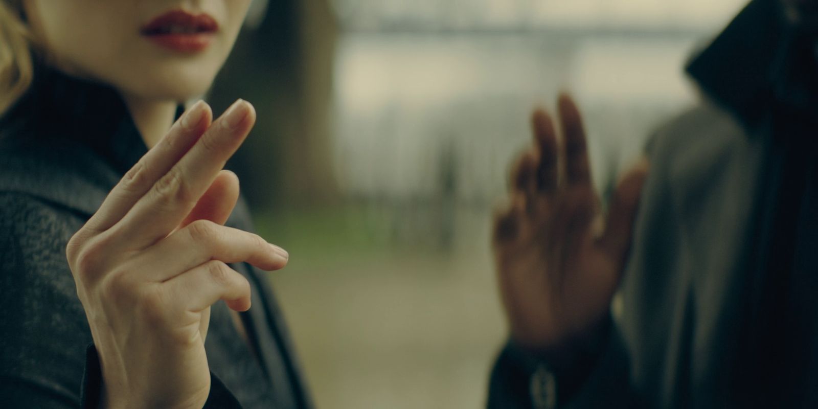 a woman holding her hands up in the air