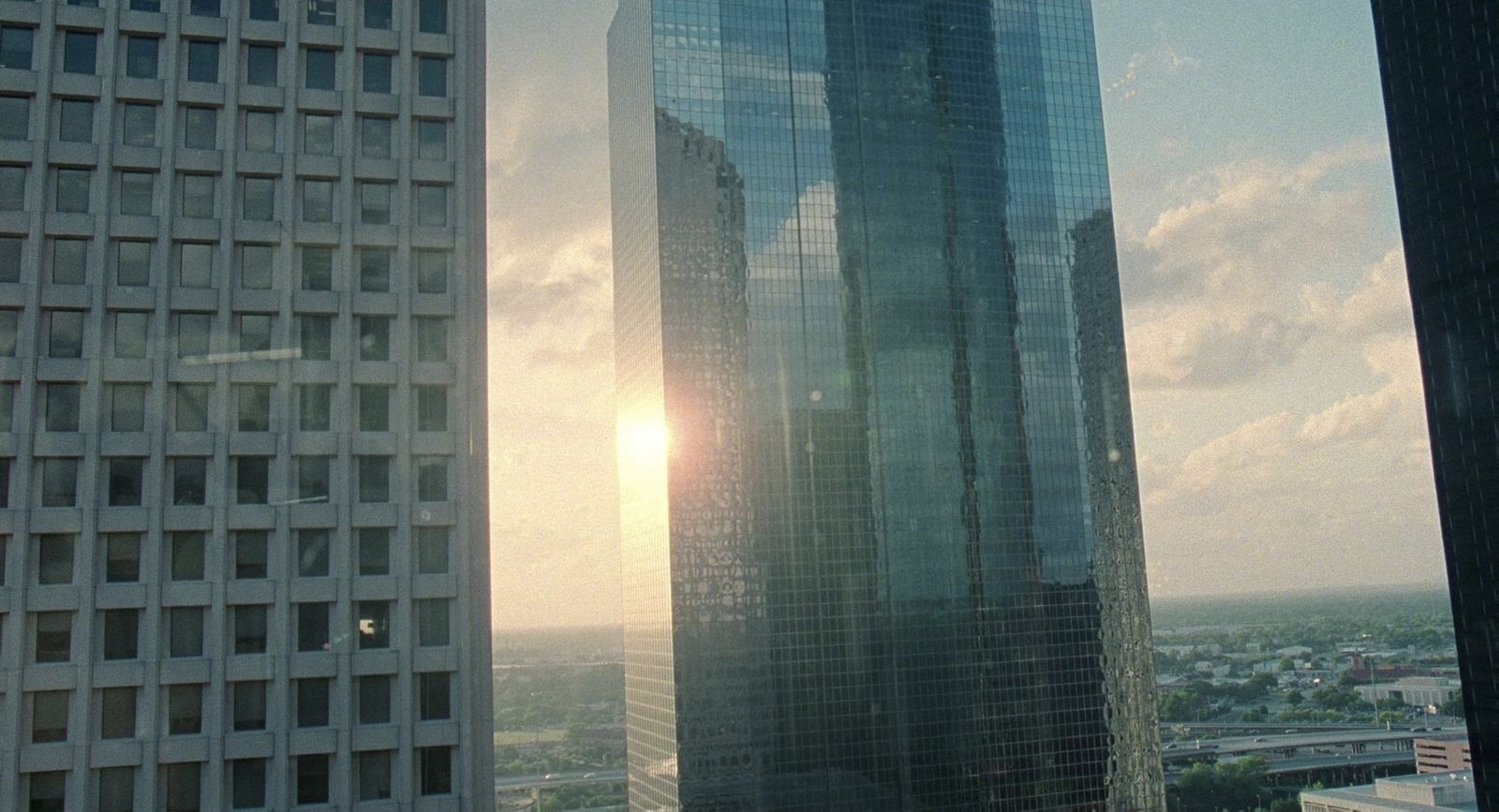 the sun shines through the windows of a skyscraper