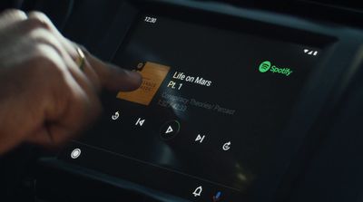 a person pressing a button on a car radio