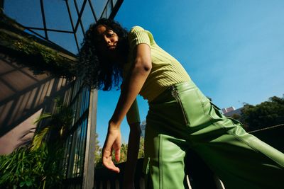 a woman in a green top and green pants