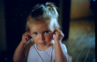 a little girl listening to music with headphones