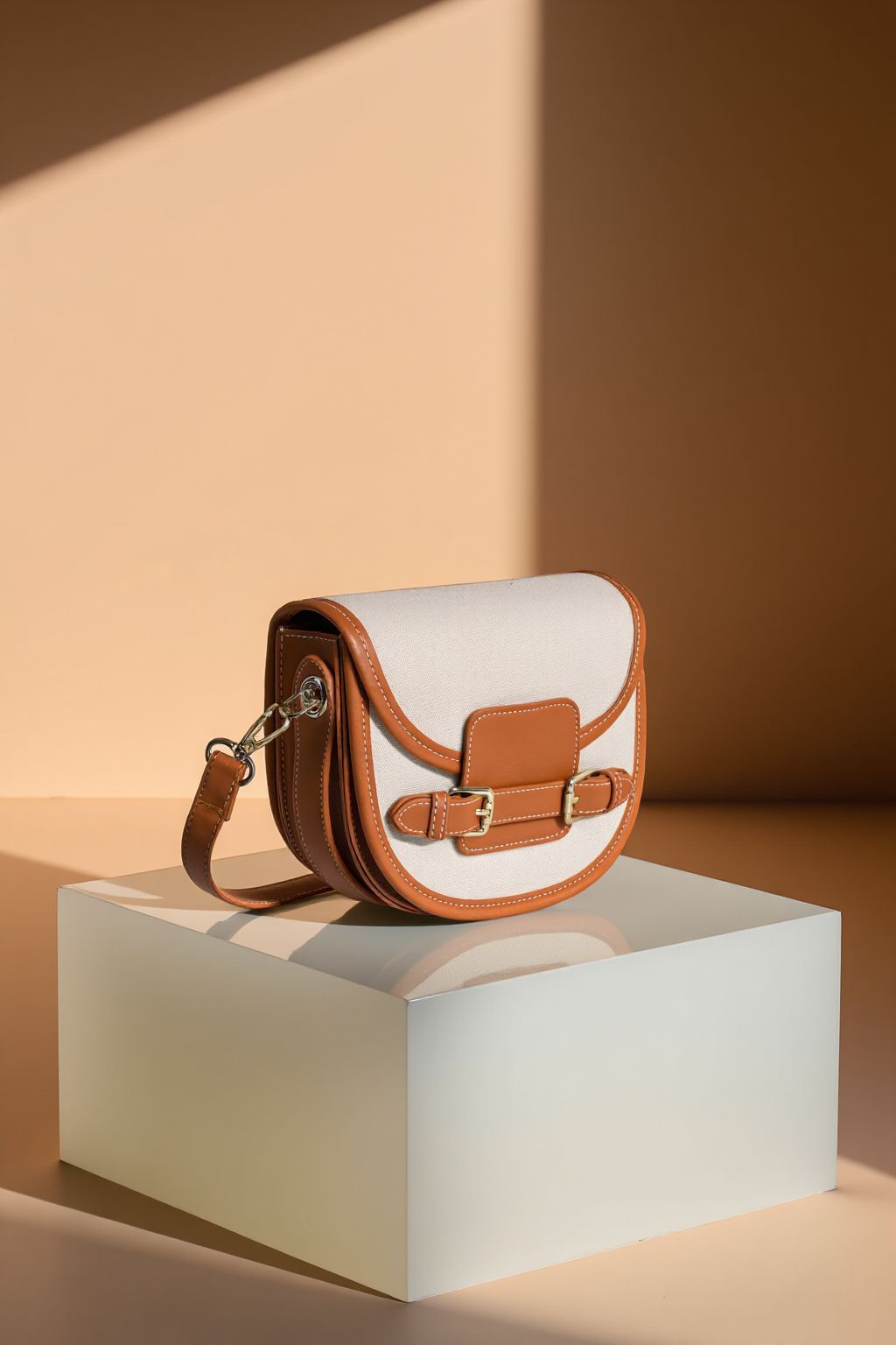 a white and brown purse sitting on top of a white box