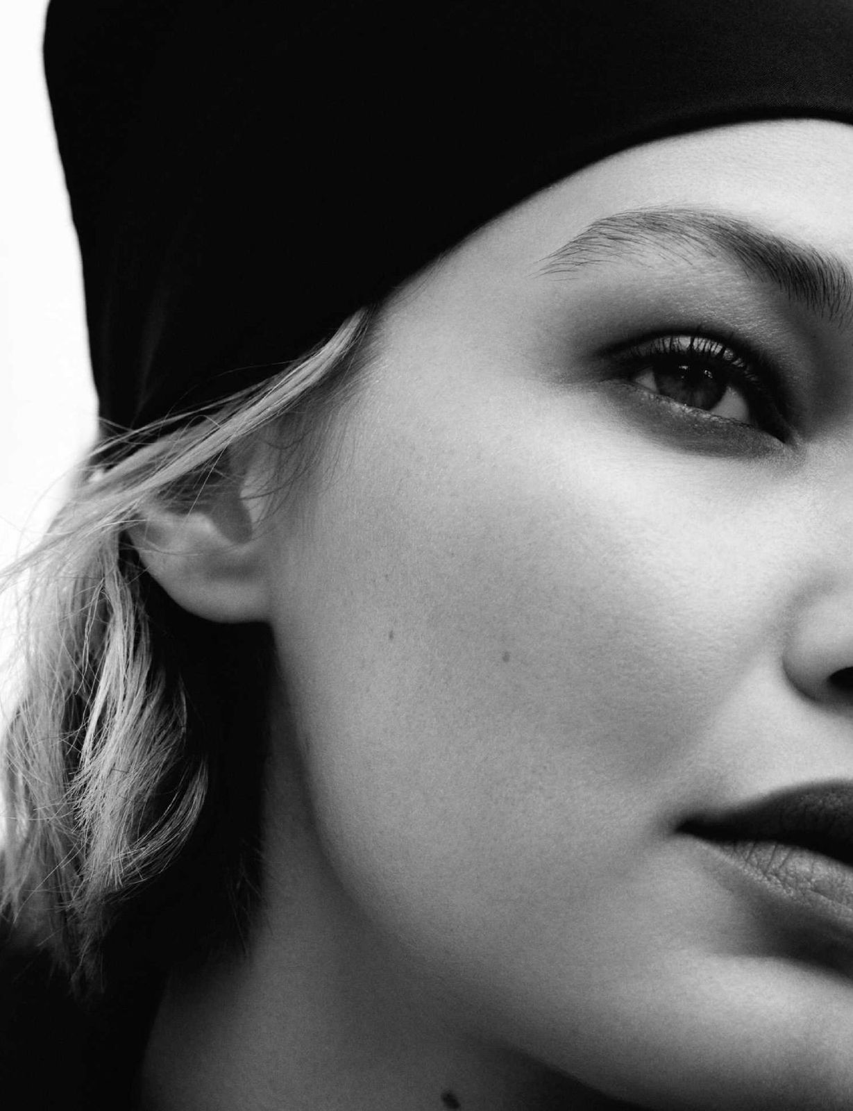 a black and white photo of a woman wearing a turban