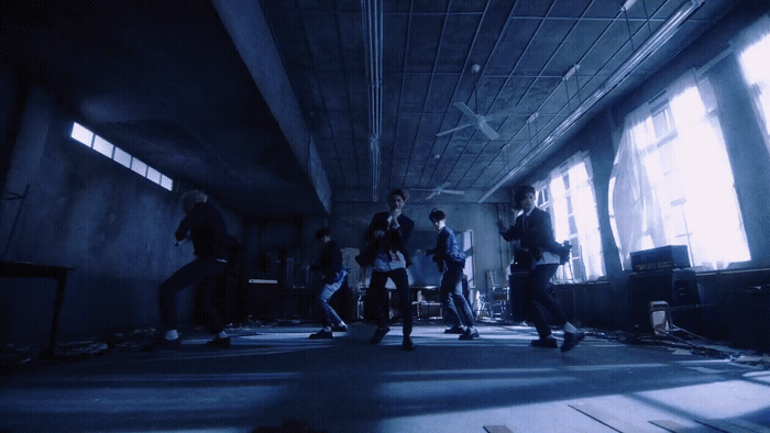a group of people standing in a dark room