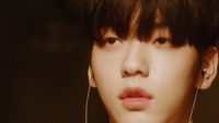 a close up of a person with ear rings