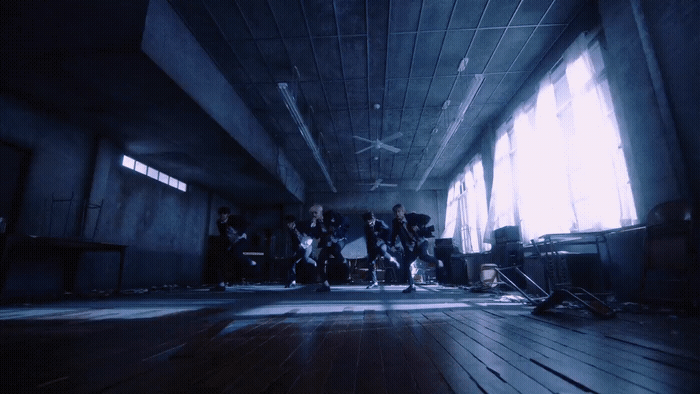 a group of people standing in a dark room