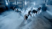 a group of people standing in a fog filled room