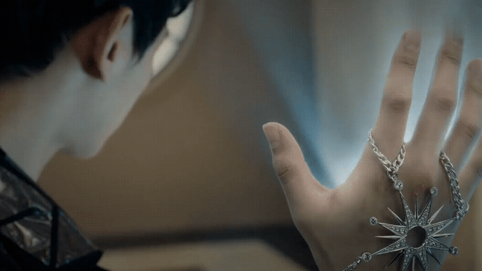 a close up of a person's hand with a ring on it