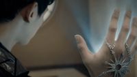 a close up of a person's hand with a ring on it