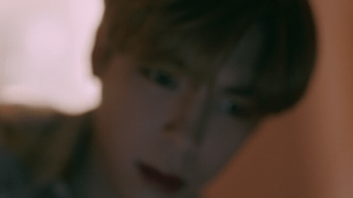a blurry photo of a person with a cell phone