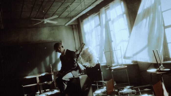 a man standing in a room with a guitar
