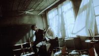 a man standing in a room with a guitar