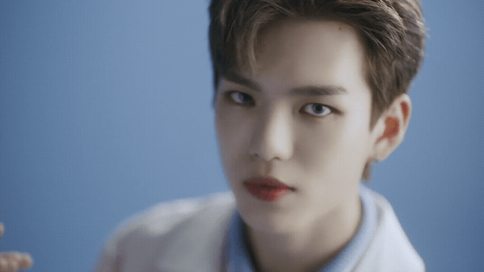 a man in a white shirt and a blue background