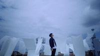 a man standing in front of a large sculpture