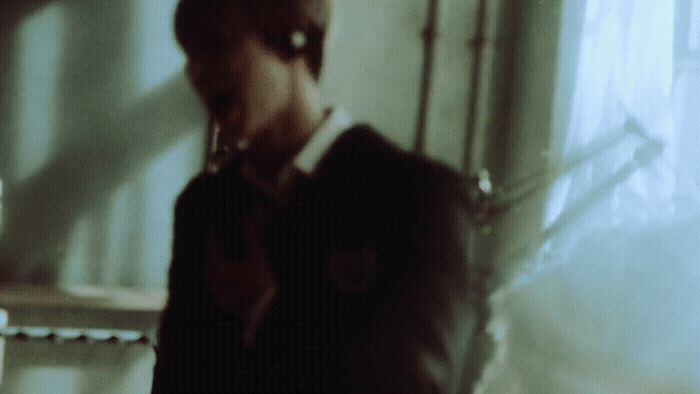 a blurry image of a woman holding a cell phone