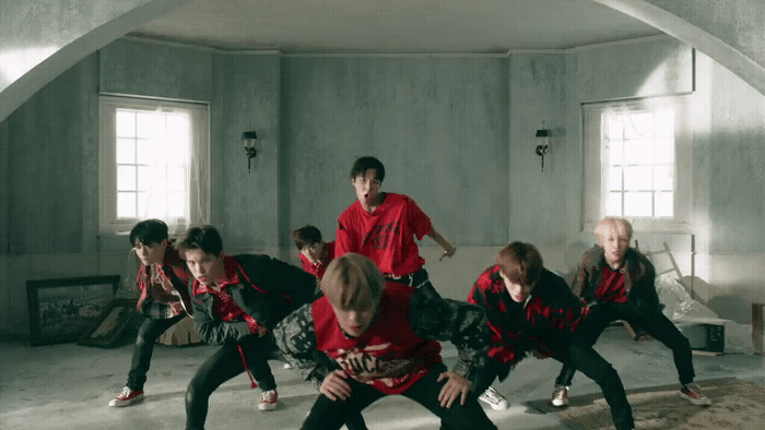 a group of young men in red and black outfits