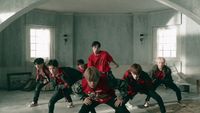 a group of young men in red and black outfits