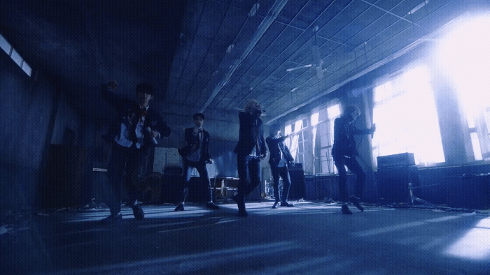a group of people standing in a dark room