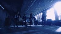 a group of people standing in a dark room
