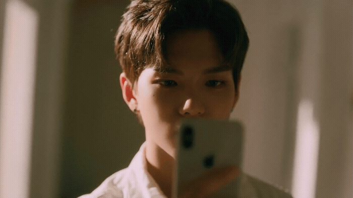 a man taking a picture of himself with a cell phone