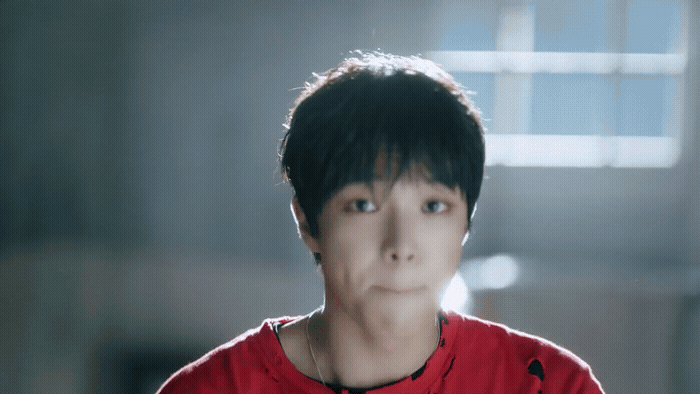 a man in a red shirt looking at the camera