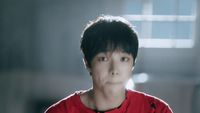 a man in a red shirt looking at the camera