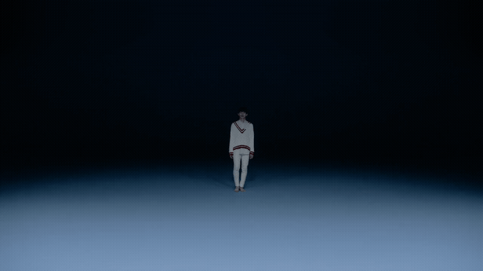 a person standing in the middle of a dark room