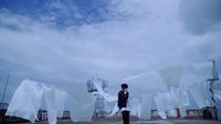 a person standing in front of a bunch of white sheets