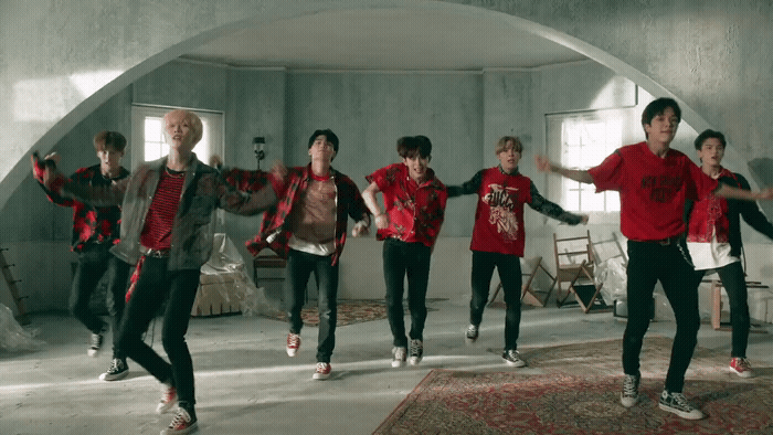 a group of young men dancing in a room