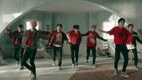 a group of young men dancing in a room