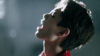 a woman in a red shirt looking up into the sky