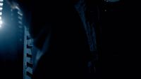 a person standing in a dark room with a light on