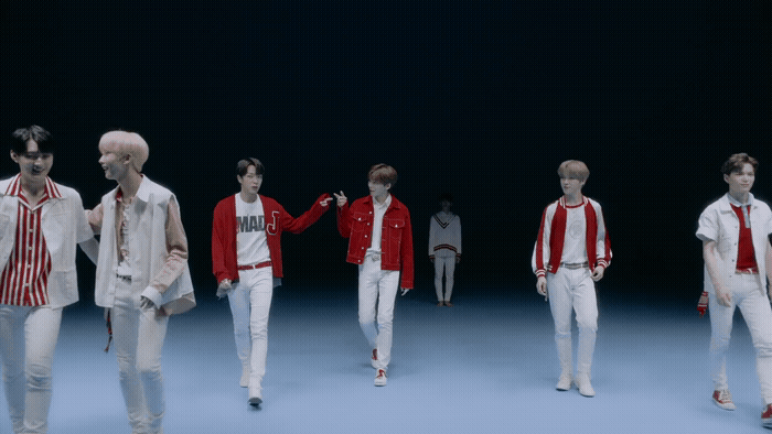 a group of young men walking down a runway