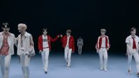 a group of young men walking down a runway