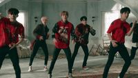 a group of young men dancing in a room