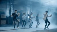 a group of young men dancing on a stage