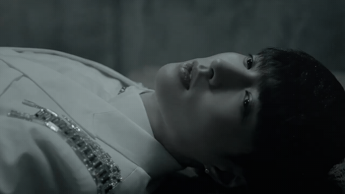 a woman laying down with her eyes closed