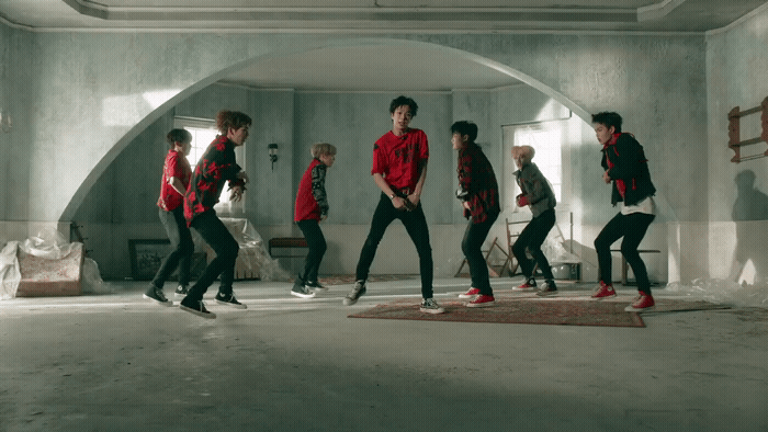 a group of young men dancing in a room