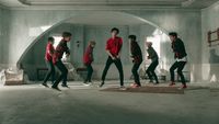 a group of young men dancing in a room
