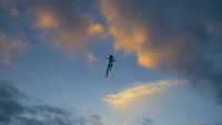 a person flying through the air on top of a kite