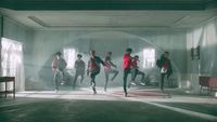 a group of young men running in a room