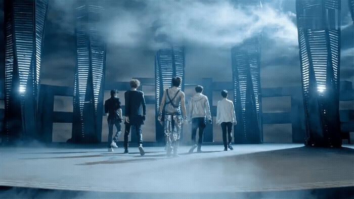 a group of men standing on top of a stage