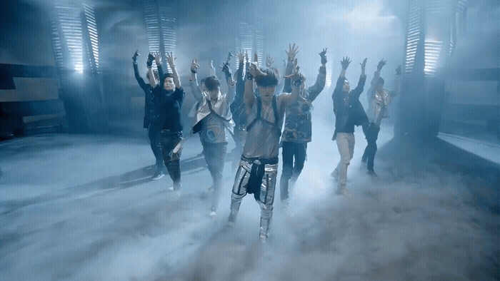 a group of people standing in a smoke filled room