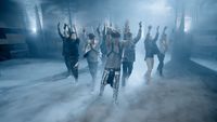 a group of people standing in a smoke filled room