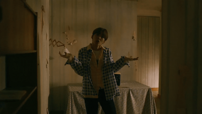 a person standing in a room with a table