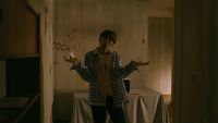 a person standing in a room with a table